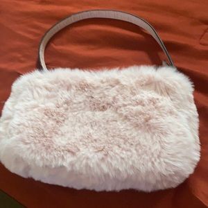 This bag is from guess. It’s fluffy and pink. Really cute and pretty